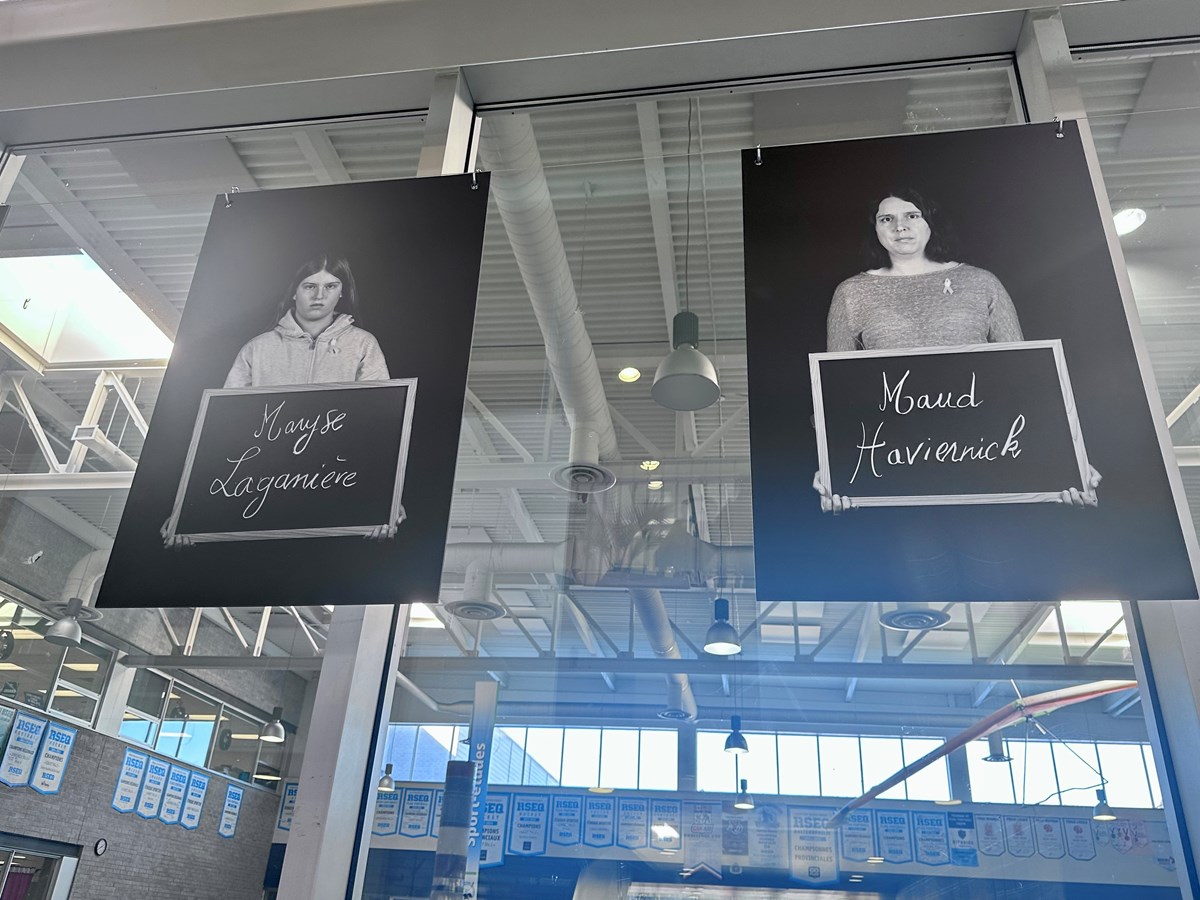 The names of two victims with photos of exhibition participants